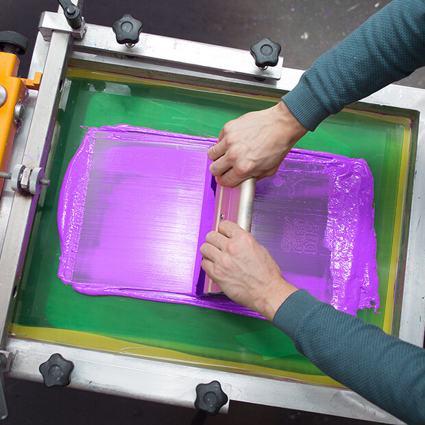 7. use a squeegee to force the ink through the mesh of the screen
